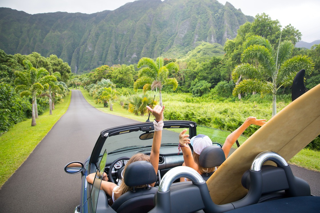 2 women in a convertible luxury car