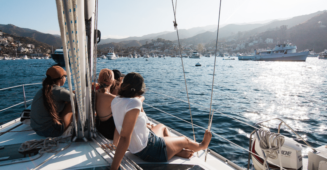 Passengers on a boat rental look at the view of Catalina Island.