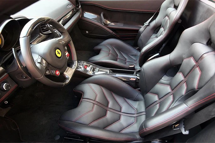 Interior of a car showing two bucket seats and a steering wheel