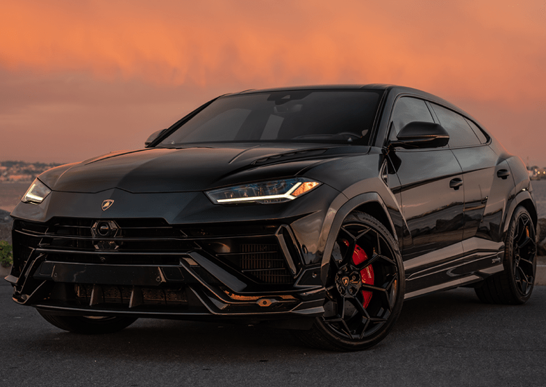 Black SUV parked with city skyline in the background during sunset